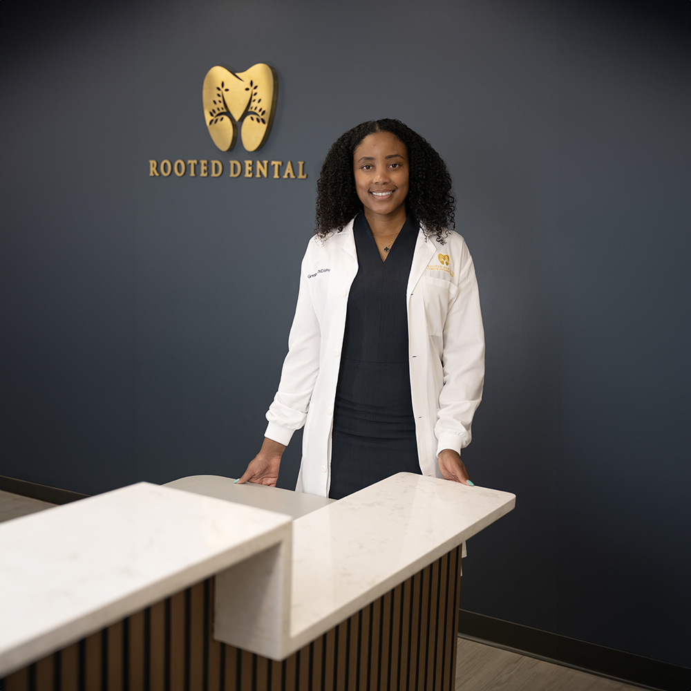 The image shows a healthcare professional performing dental work on an elderly patient in a clinical setting.